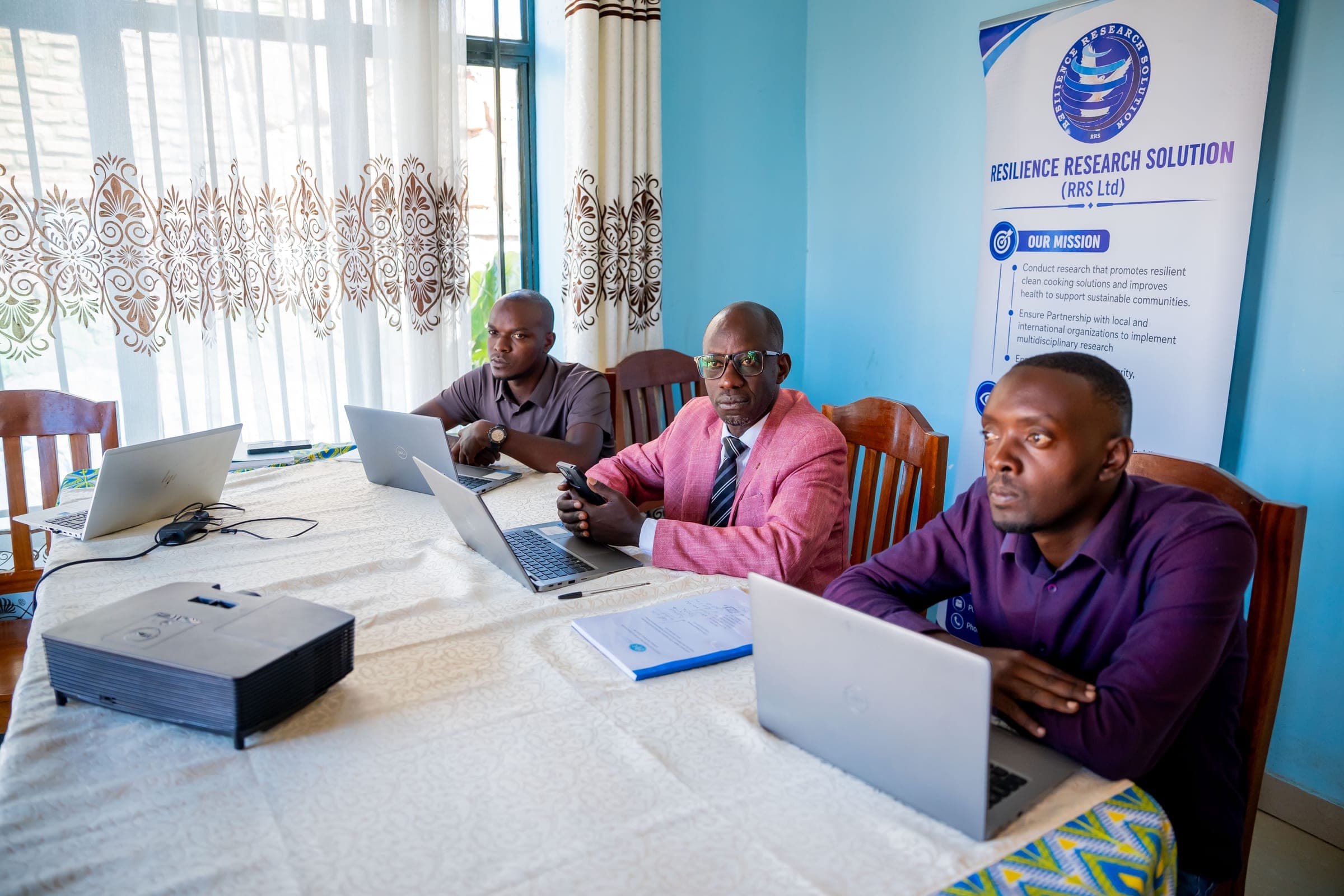 The RRS research team reviewing project data at the Kamonyi office